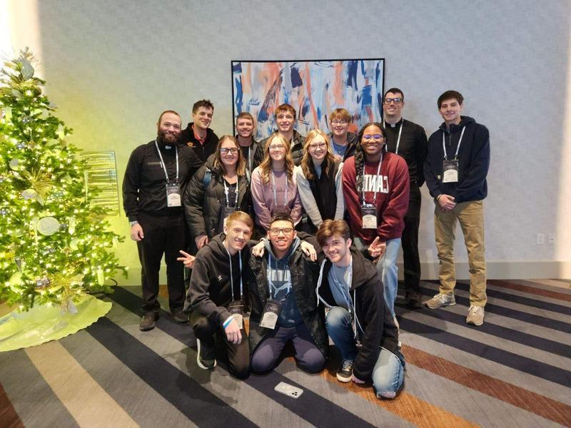 Blazer Catholic members posing for a photo at a conference